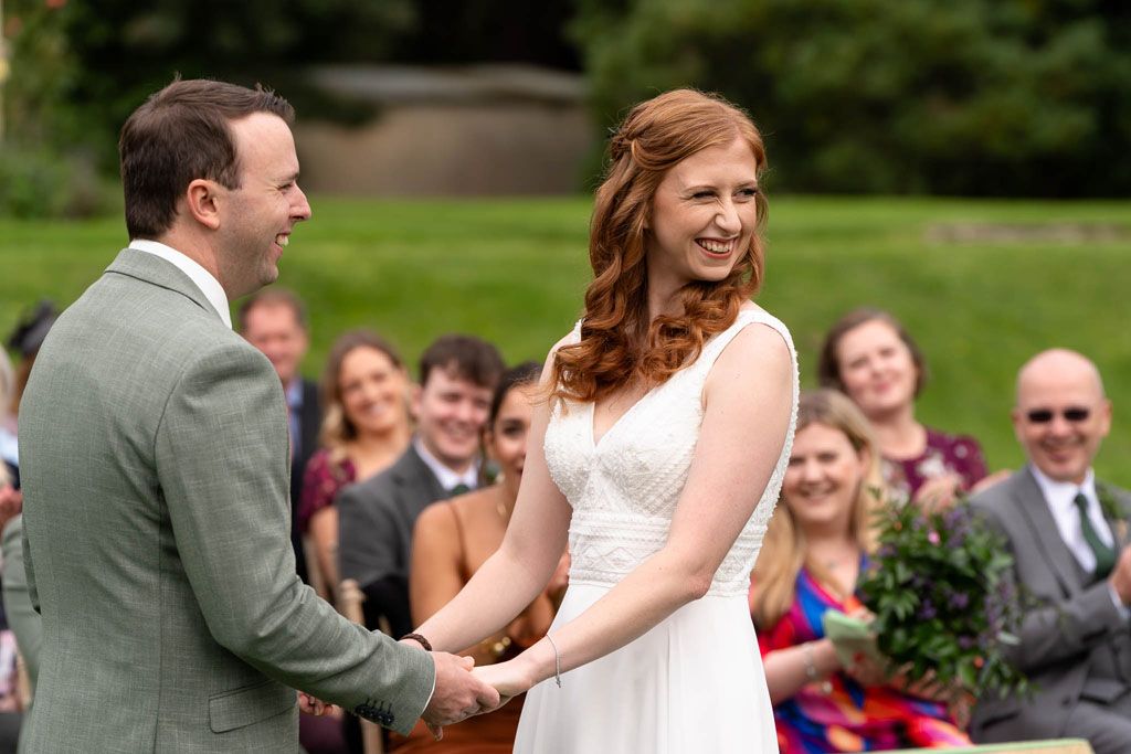 Bride & Groom holding hands at Holne Park House