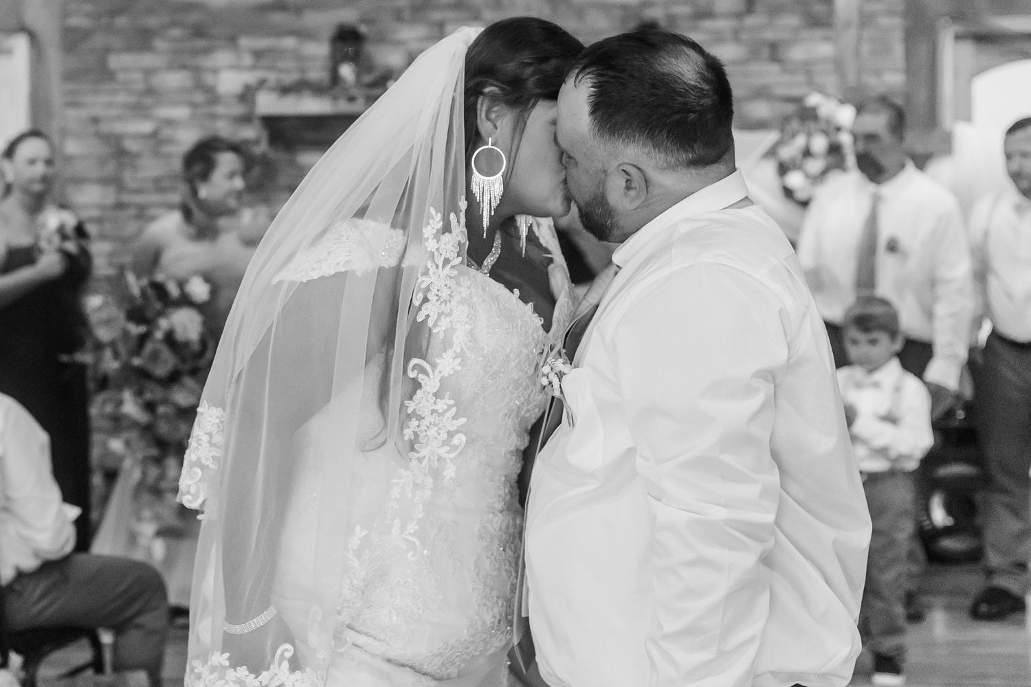 Black and white wedding reception photos showing guests dancing and celebrating.