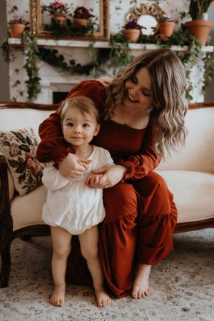 A series of intimate lifestyle photos showing tender moments between parent and child on a couch.