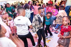 Lively party scene with guests dancing and celebrating in a crowded venue.