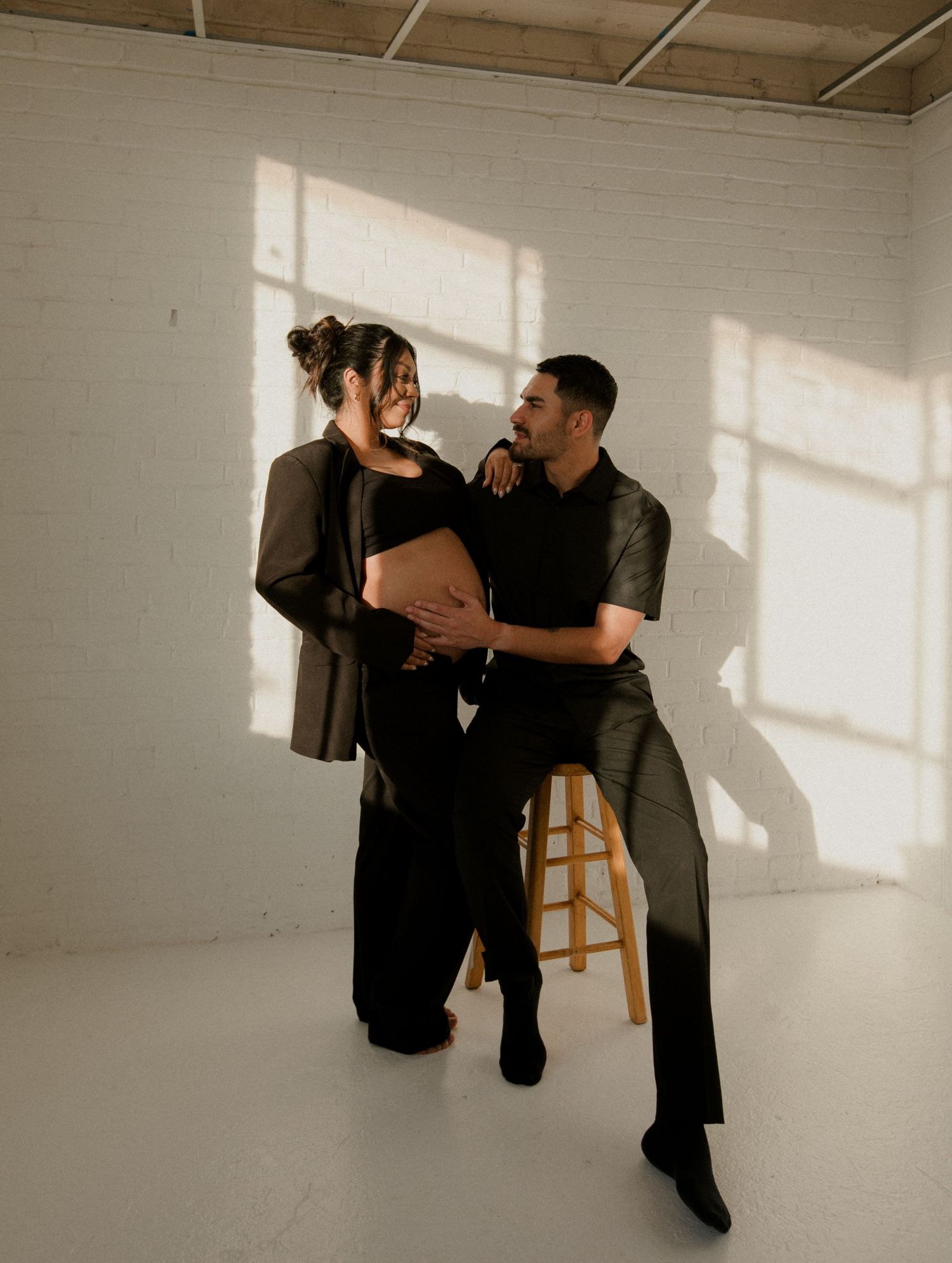 Artistic dance performance sequence in a white studio space with dramatic lighting.