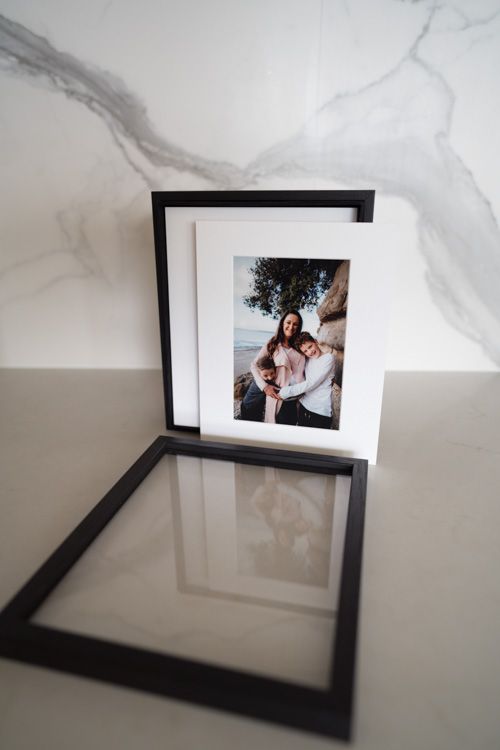 acrylic story box with lid open showing a matted print of a mum and two sons