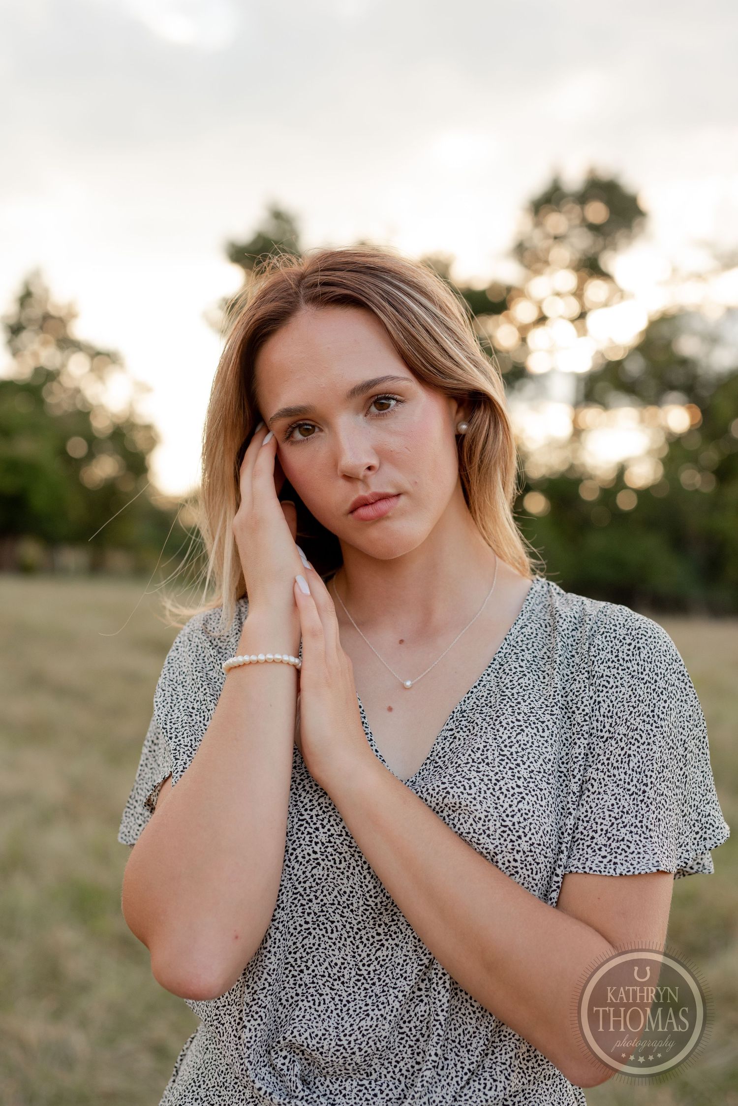 Intimate portrait wearing floral v-neck top in warm evening light.