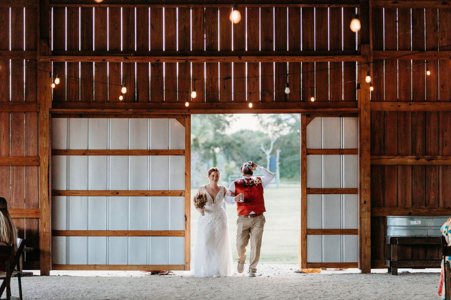 A dramatic entrance into a rustic barn venue through large sliding doors.