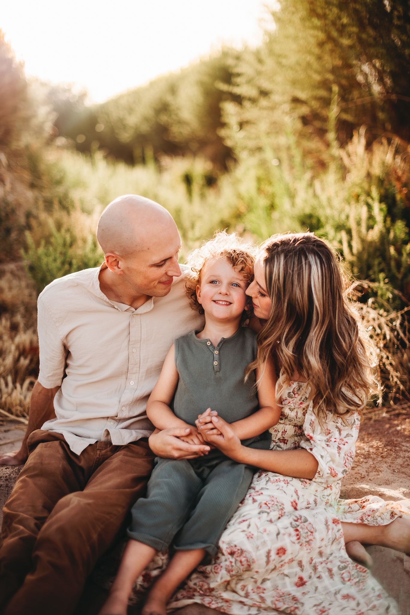 A family shares a cozy moment together outdoors during golden hour.