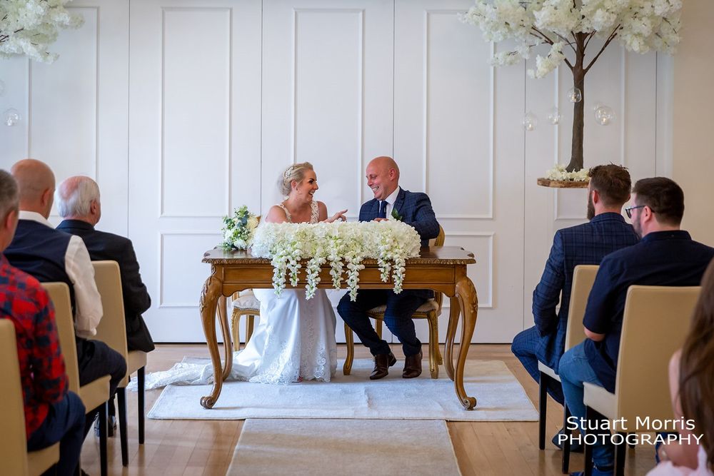 Bride and groom signing the register at west tower country house hotel.