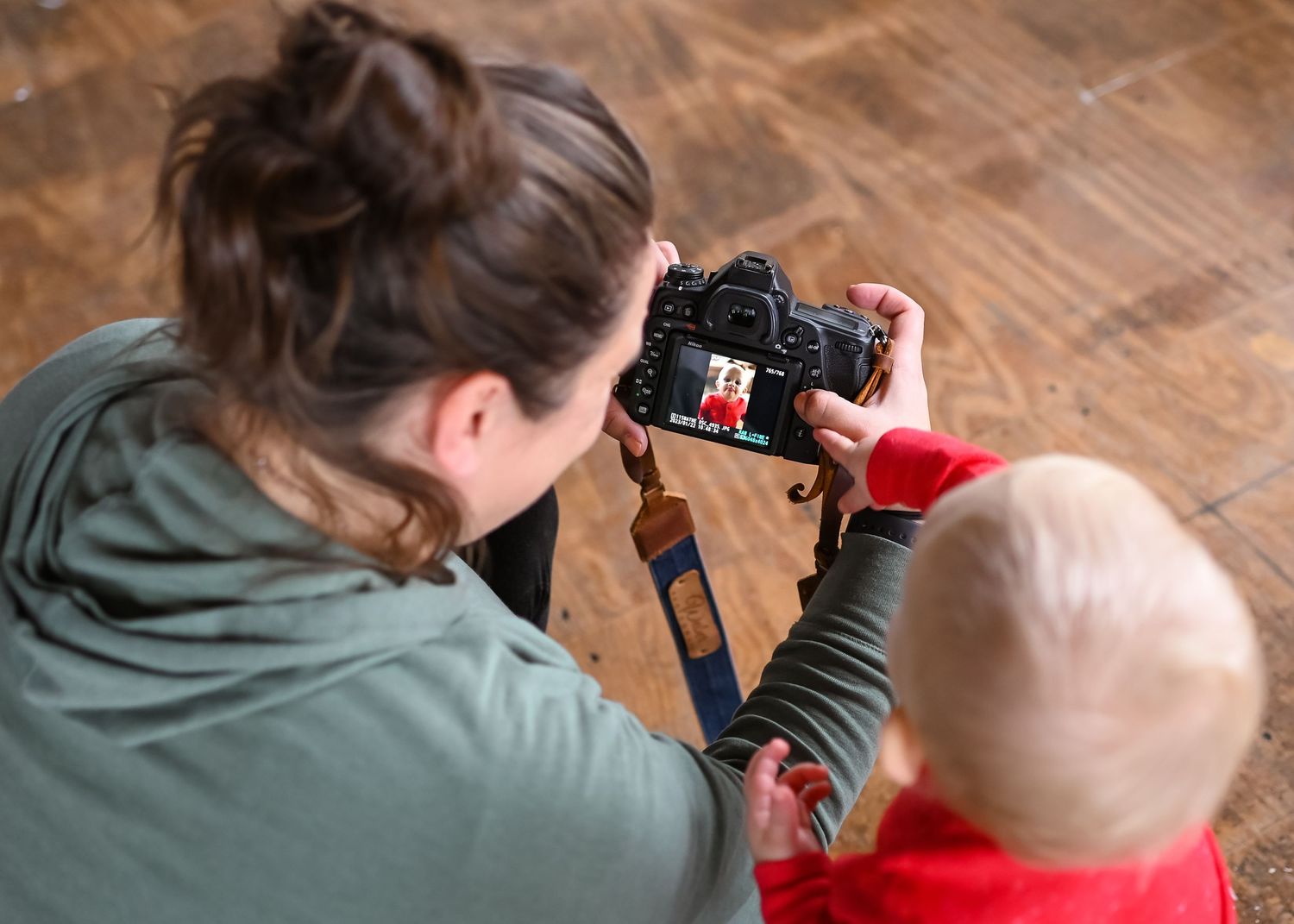 Reviewing photos on a camera display while touching the screen together.
