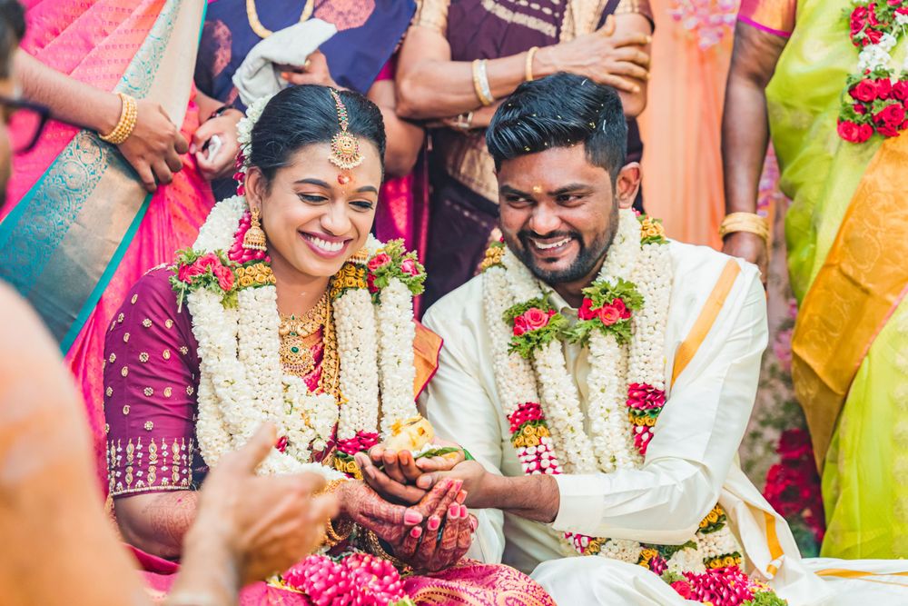 Traditional ceremony participants seated during cultural rituals with floral decorations.