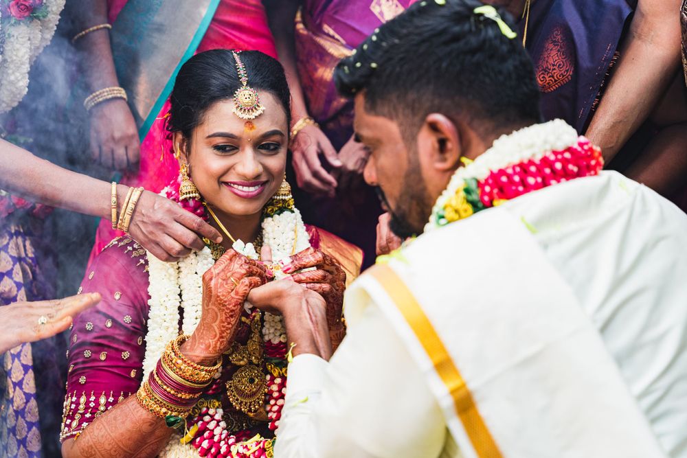 Traditional ceremony participants performing sacred rituals amid colorful decorations and smoke.