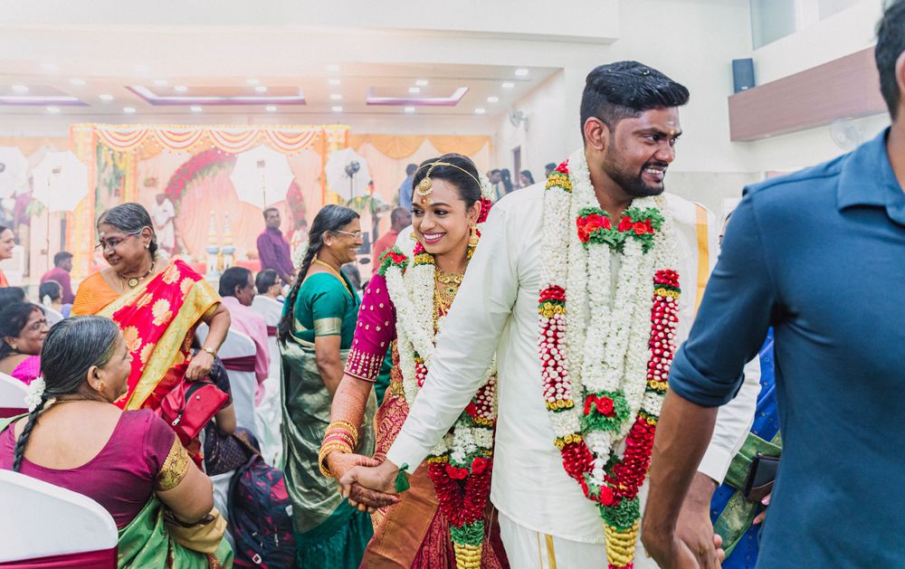 Wedding guests and participants gather during traditional South Indian ceremony with festive decorations.