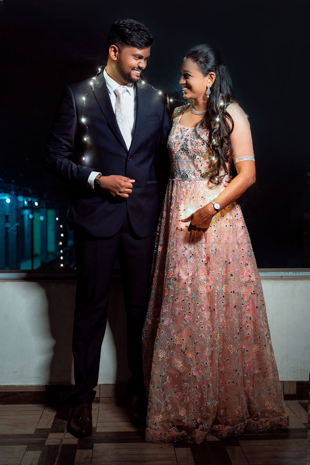 Formal evening portrait with sparkly lighting and elegant attire.