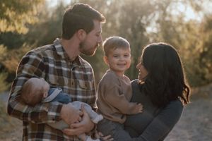 A heartwarming family moment captured outdoors during golden hour.