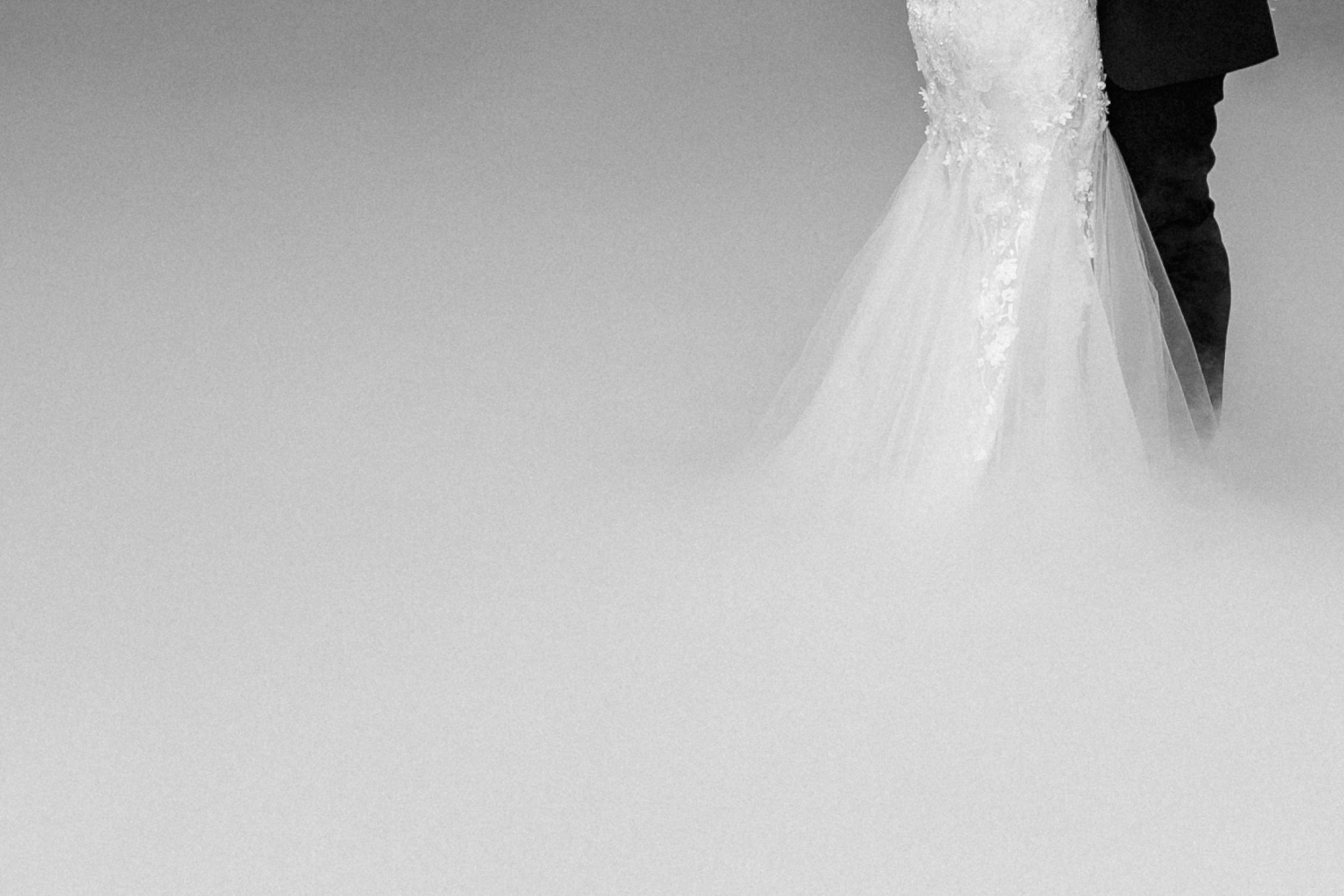 Details of a couples first dance amongst smoke.
