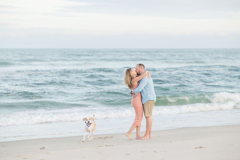 Romantic beach photoshoot at sunset with the ocean waves in the background.