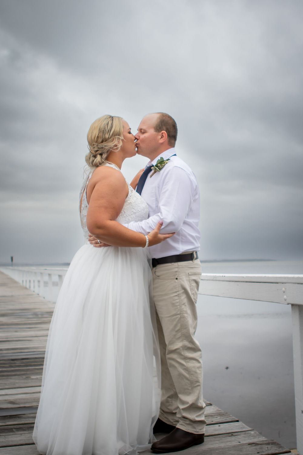 Husband and wife kissing on their wedding day