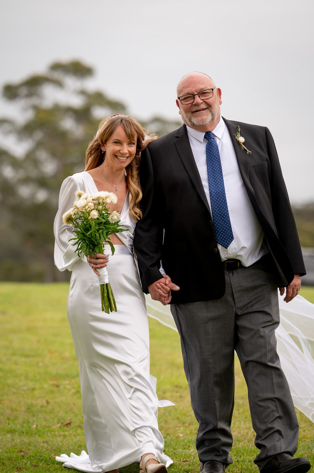 Bride being walked down the aisle with her dad