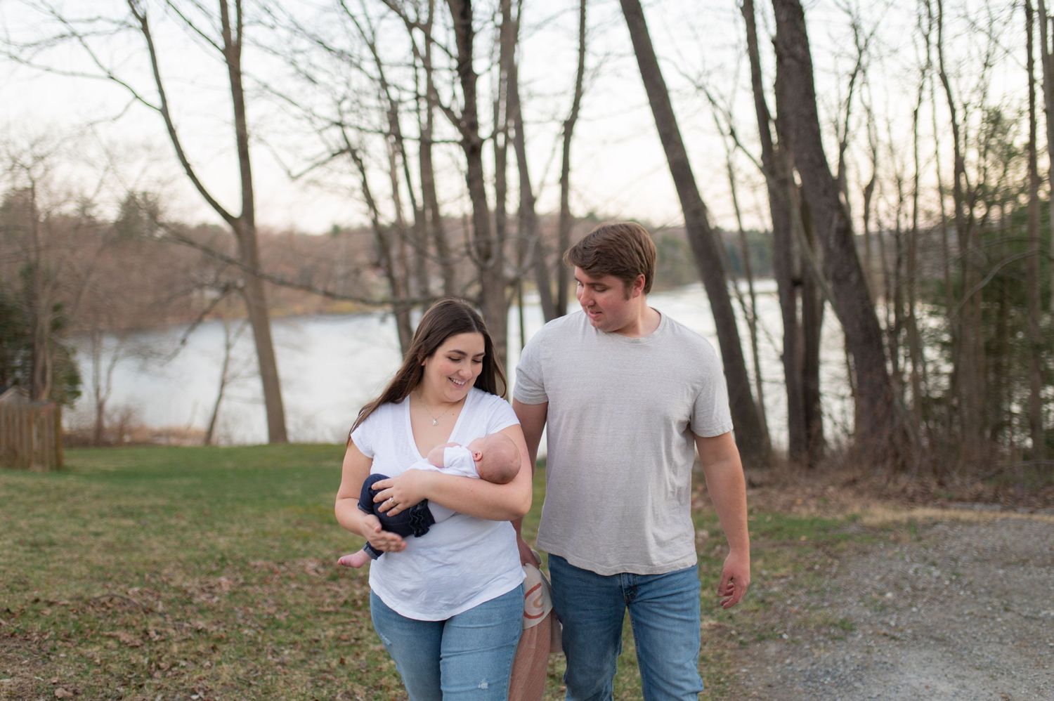 Couple taking a walk together along a path by a winter lake.