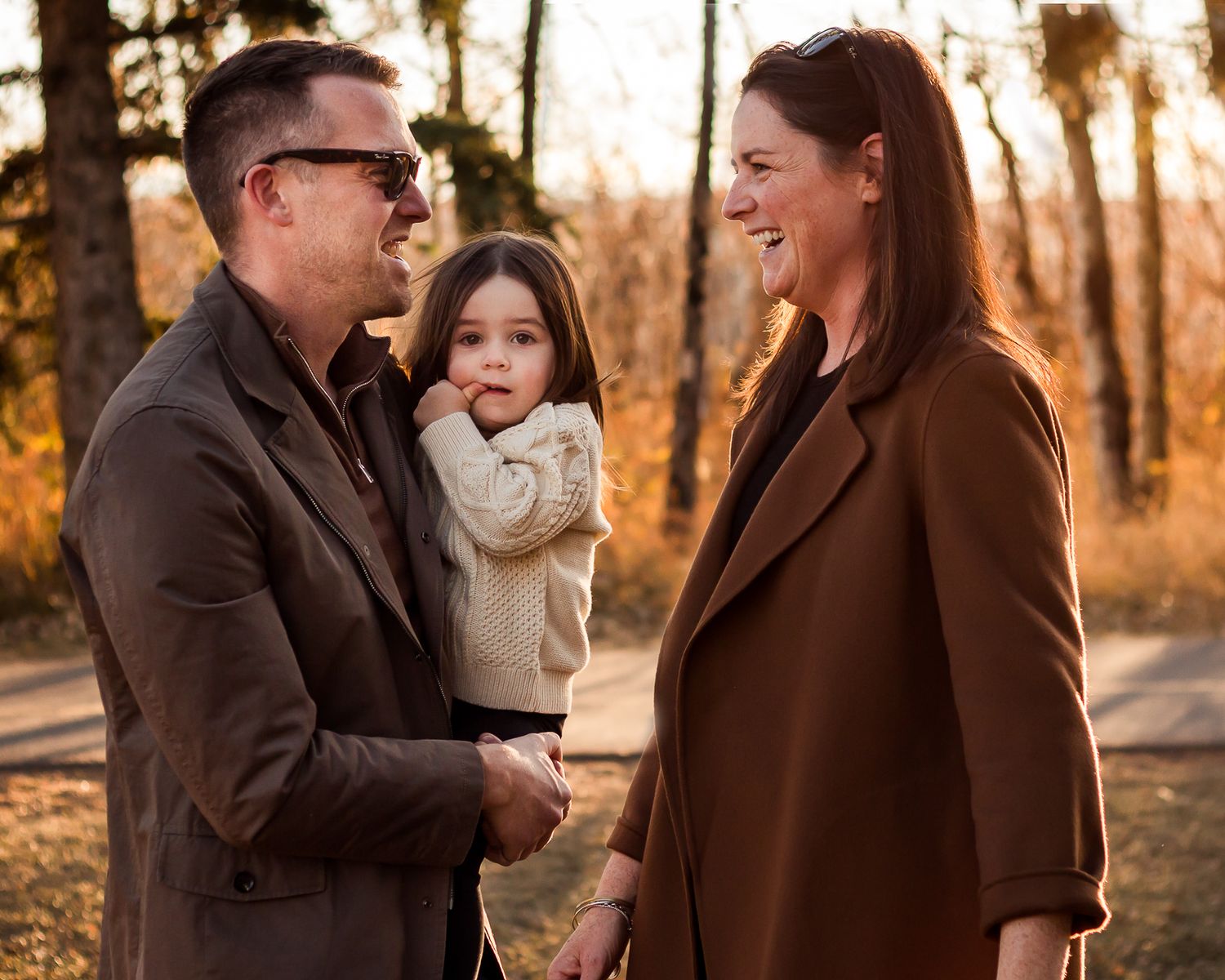 Beautiful fall family photos during golden hour at Glenmore Reservoir in Calgary AB.