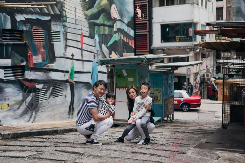 Family photoshoot sequence in an urban alleyway with artistic graffiti background.