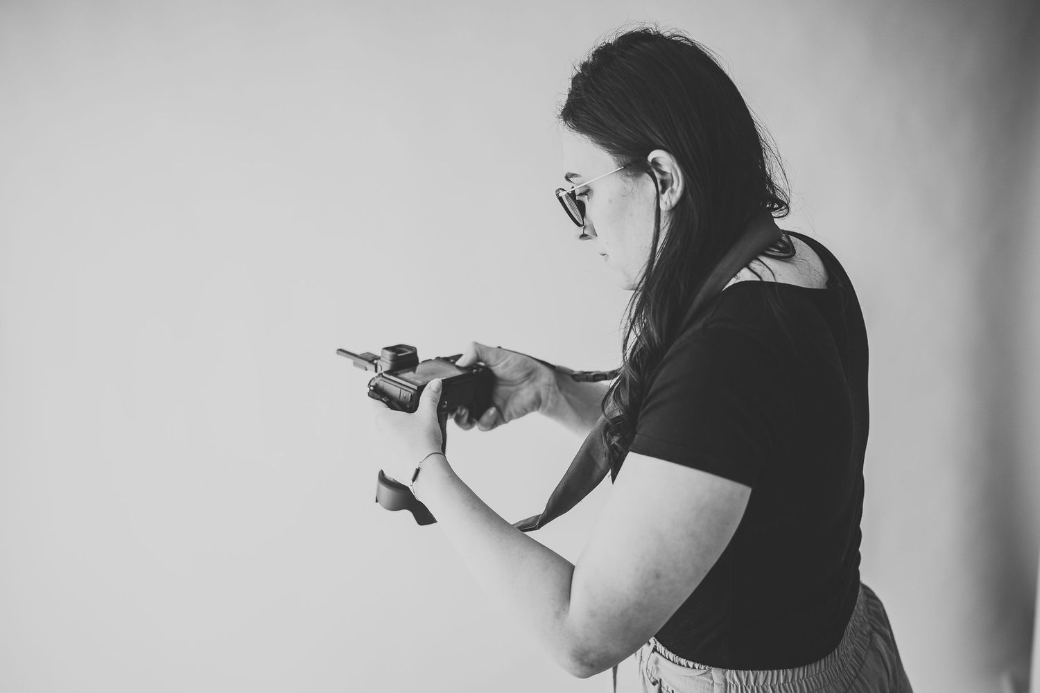 Photographer capturing a newborn session in the studio, adjusting lighting and setting up for the perfect shot – behind-the-scenes
