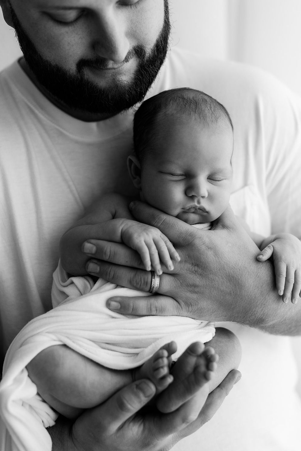Studio photography image of father holding newborn baby boy. Black and white. Jen Roberts Photography, Mesa AZ
