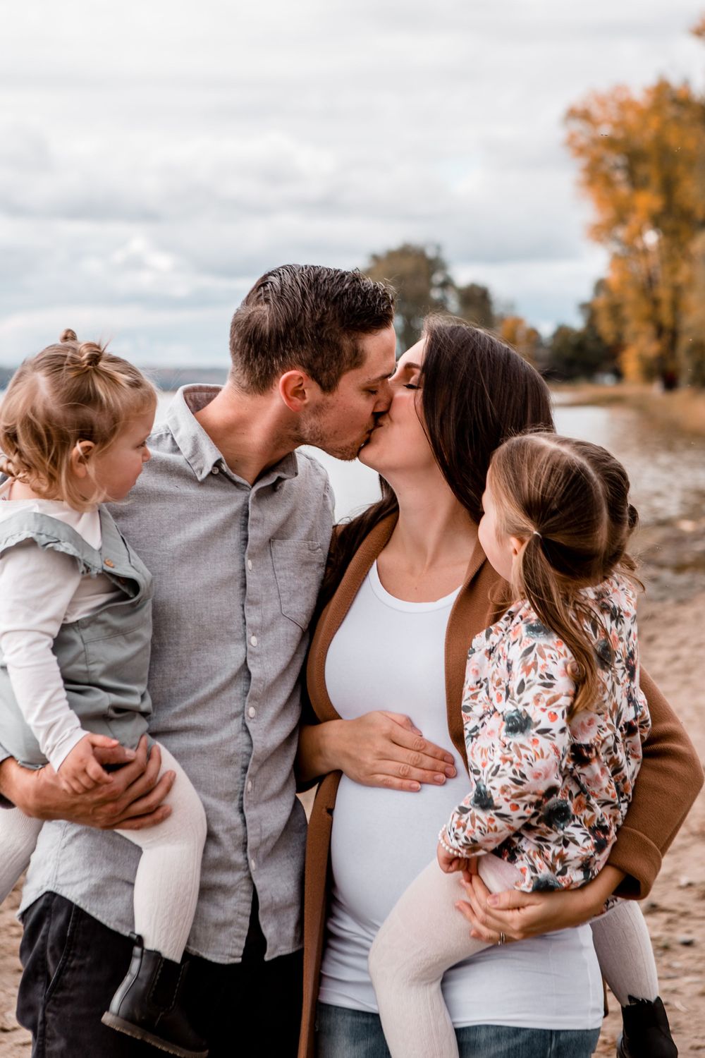A family photoshoot sequence on a beach with fall colors in the background.