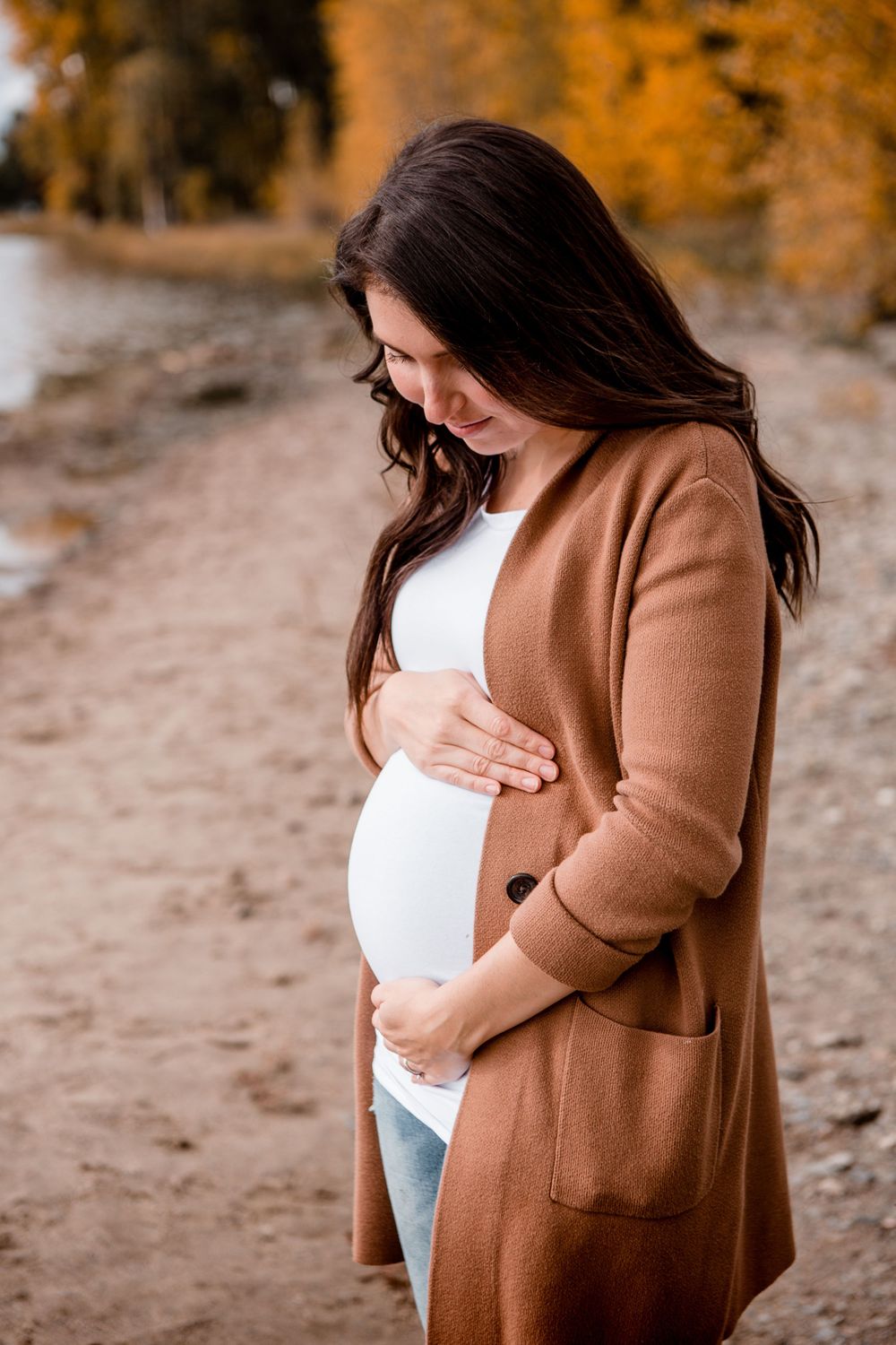 Maternity photoshoot sequence showing person in brown cardigan against autumn beach backdrop.