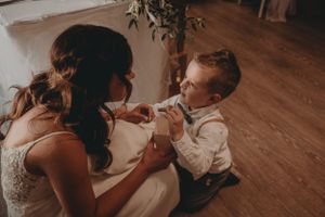 A sweet moment shared during a wedding reception on a wooden dance floor.