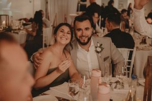 A candlelit wedding reception with guests enjoying the celebration.
