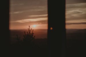 A dramatic sunset view through windows creating a warm silhouette.