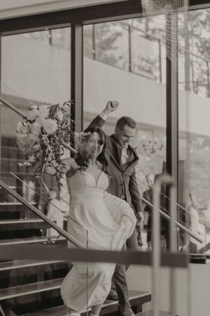 A couple walking down modern stairs in black and white photography.