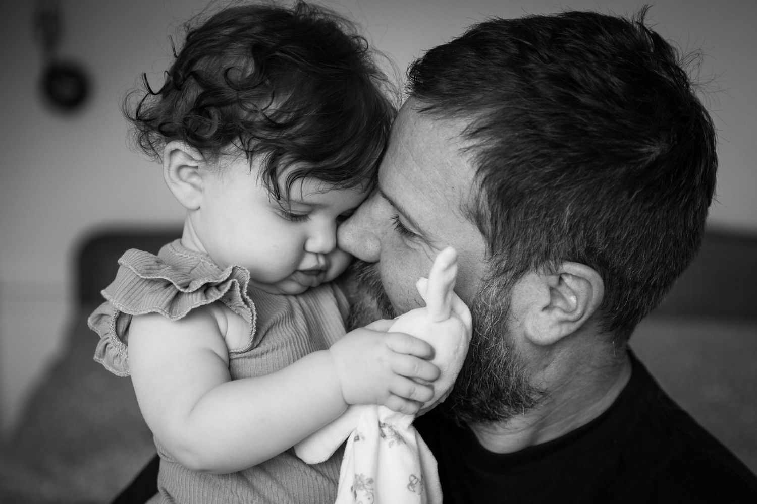 Dad and your daughter nose to nose snuggling with soft toy