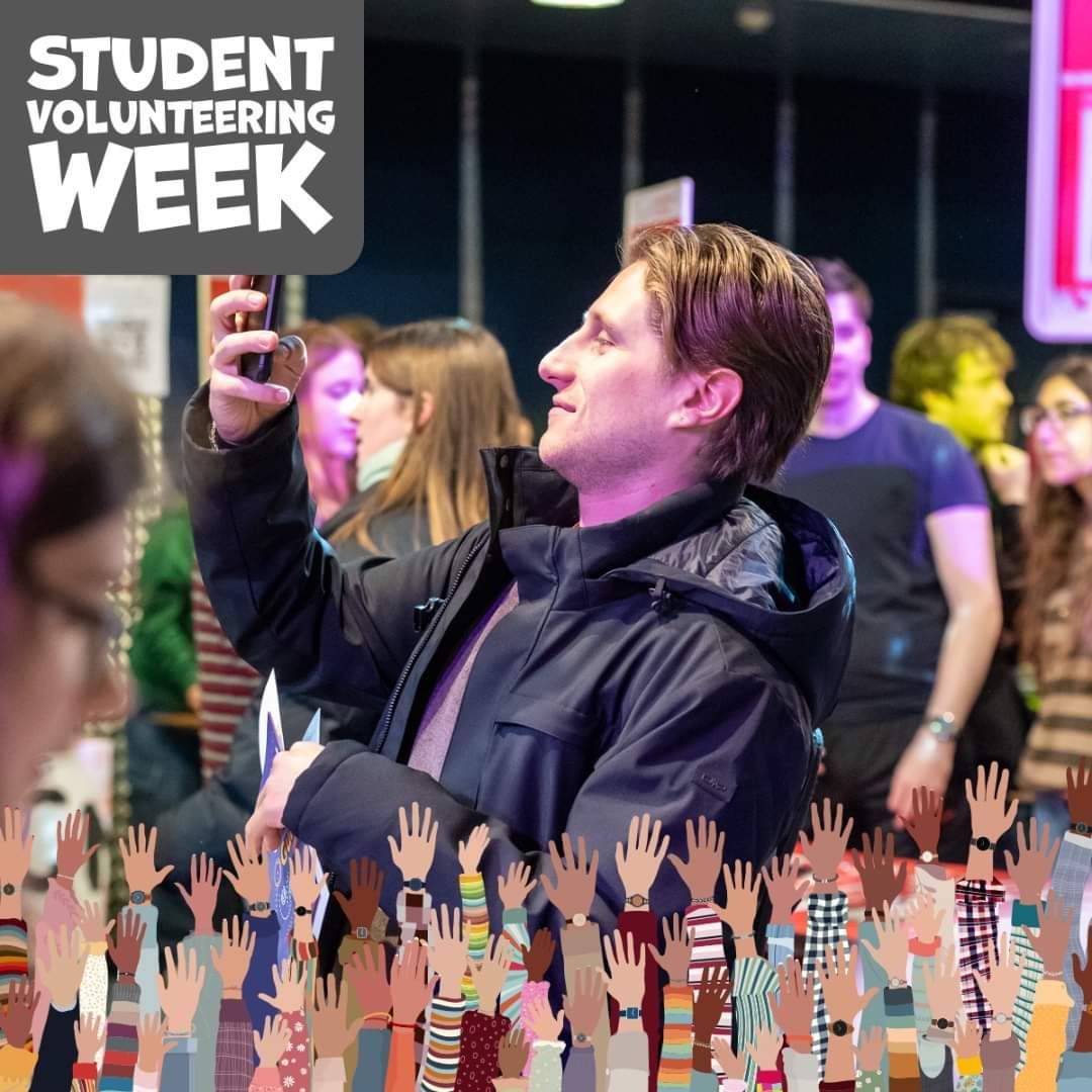Enthusiastic crowd at student volunteering week with illustrated hands overlay.