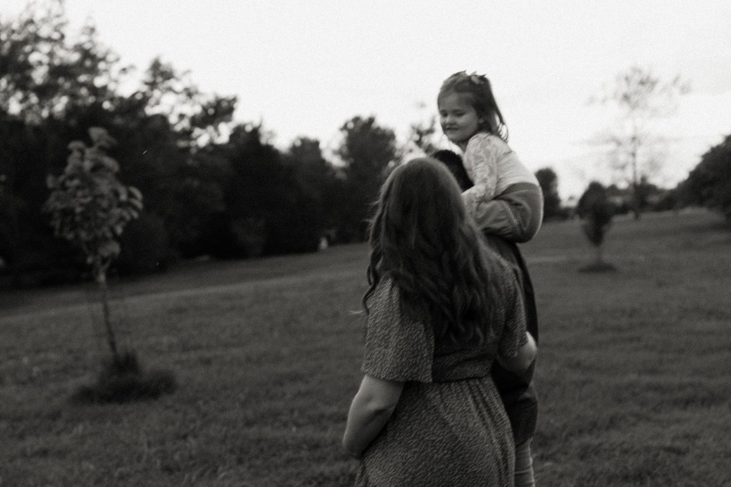 Candid family portrait in Joplin, Missouri captured in natural light by Modern Moods Imagery, showing genuine connection and movement.