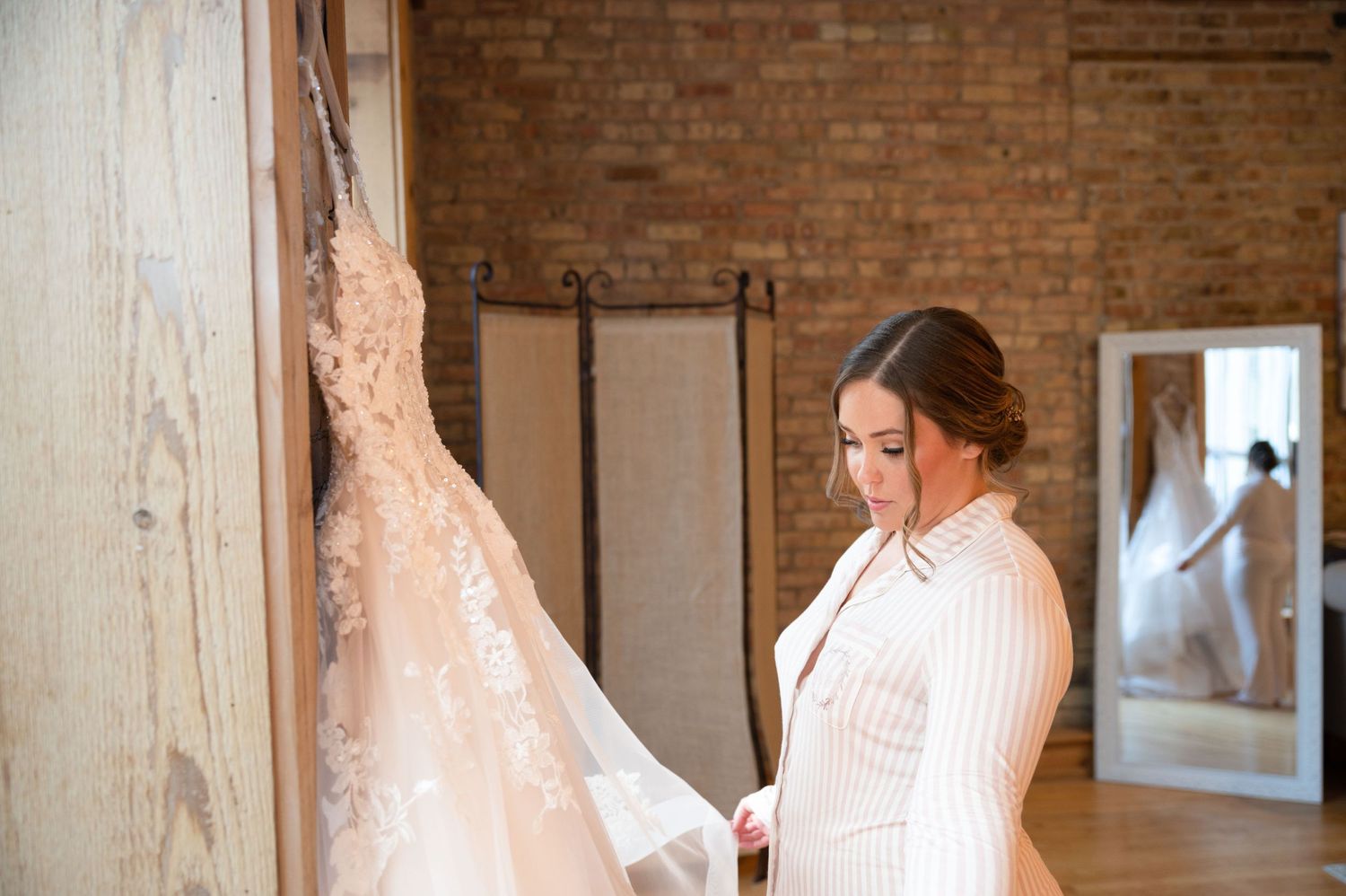 bride holding wedding dress mirror reflection highland loft