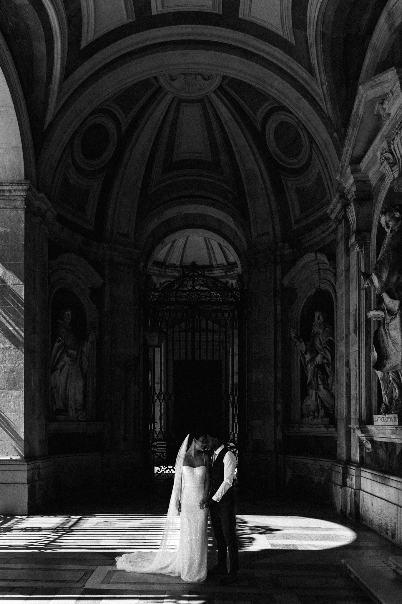 Dramatic shadows play across ornate cathedral architecture in black and white photography.