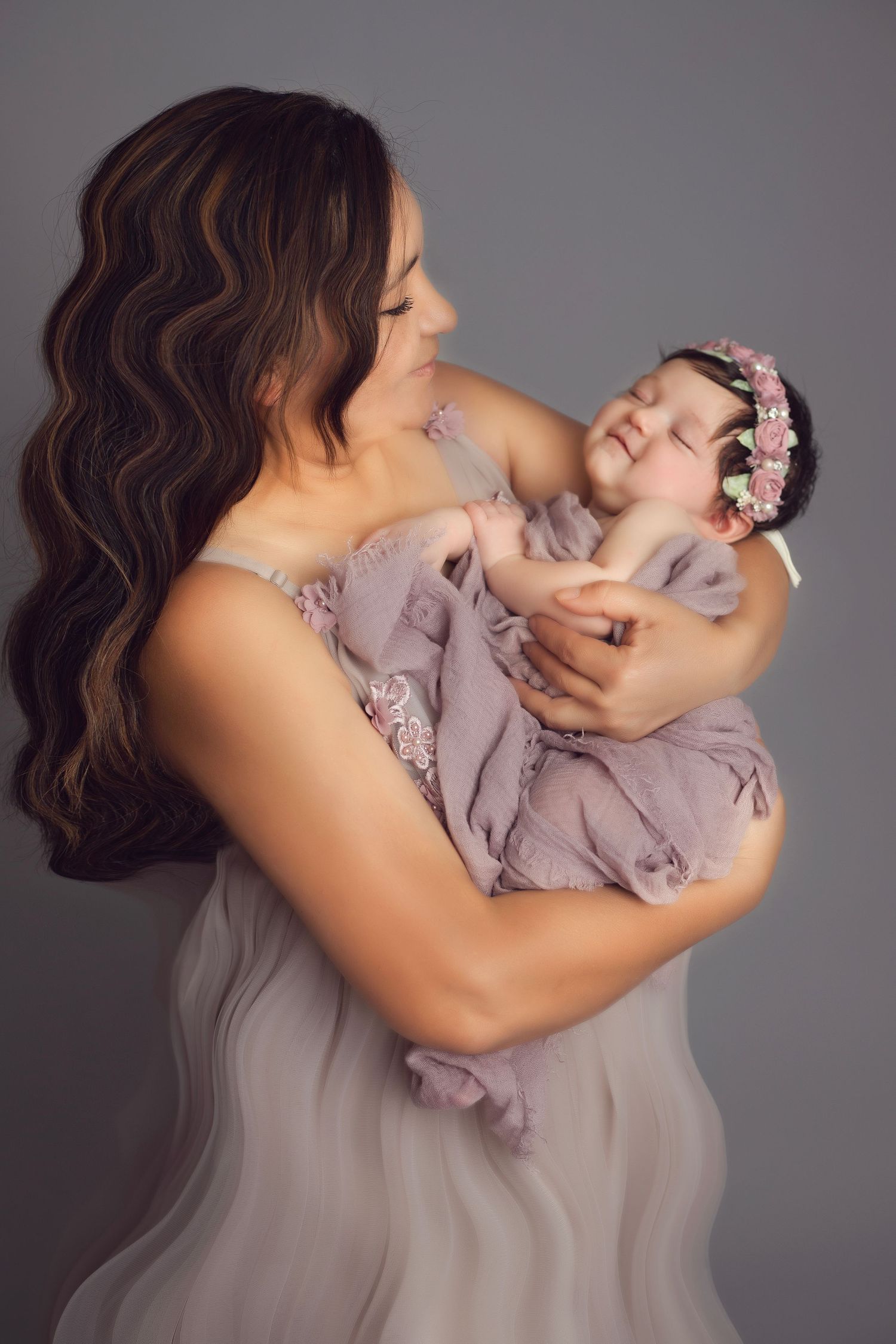 Dreamy portrait series with flowing lavender dress against grey backdrop.