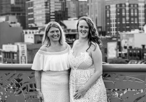 Urban family portraits in black and white with city buildings in background.