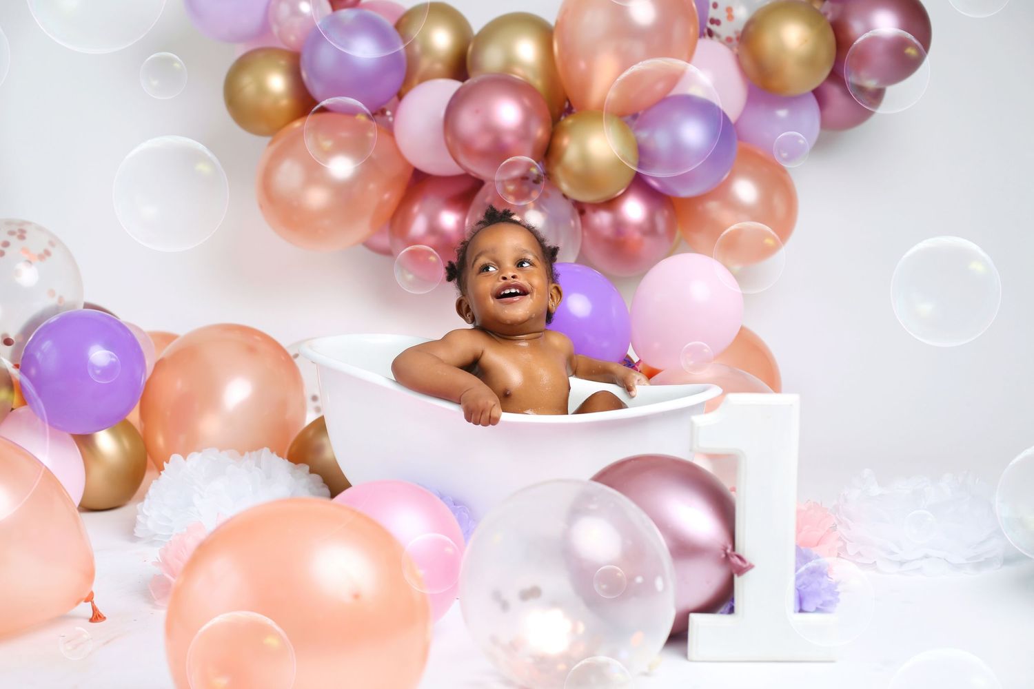 baby girl's first birthday splash in a tub session portrait photo
