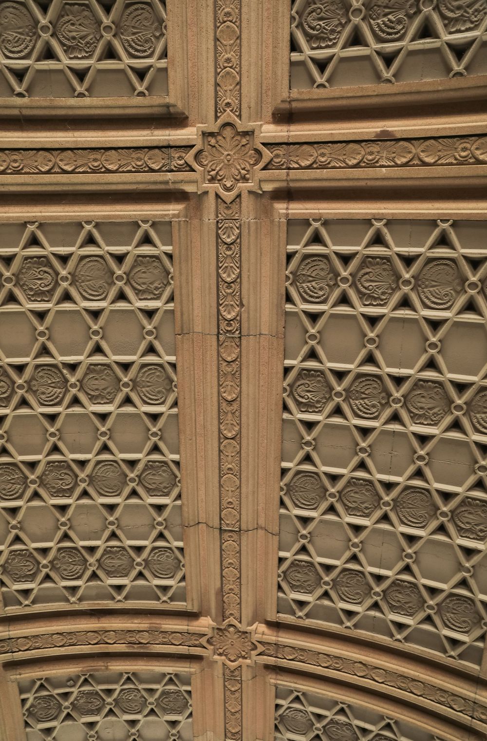 Ornate architectural detail of wooden panels with geometric Islamic patterns and decorative crosses.
