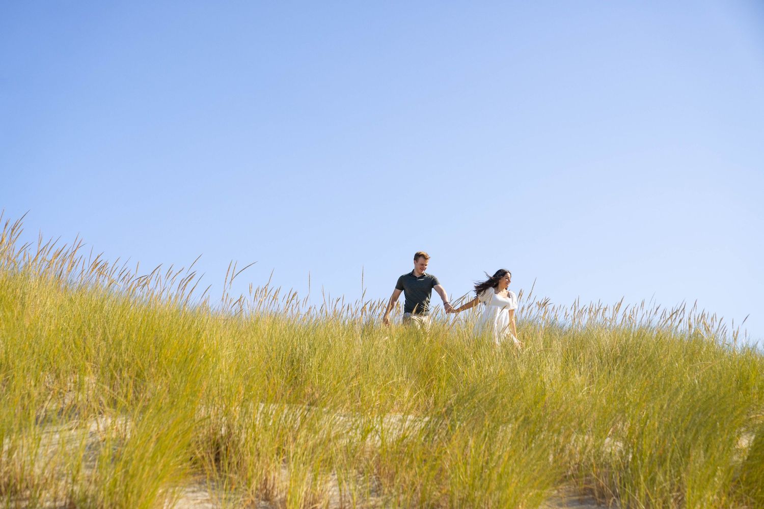 Alex Davis Photography: Couples Engagement Photoshoot Running Over Dunes At Cannon Beach On Oregon Coast