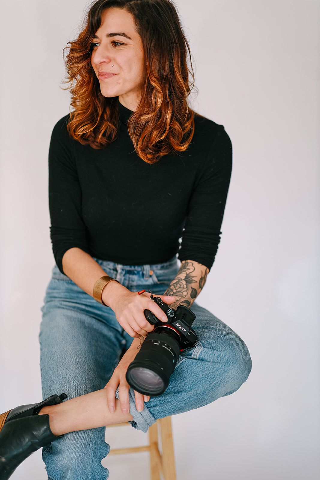Brande Studios photographer Sophie Brande headshot. Sophie holding camera