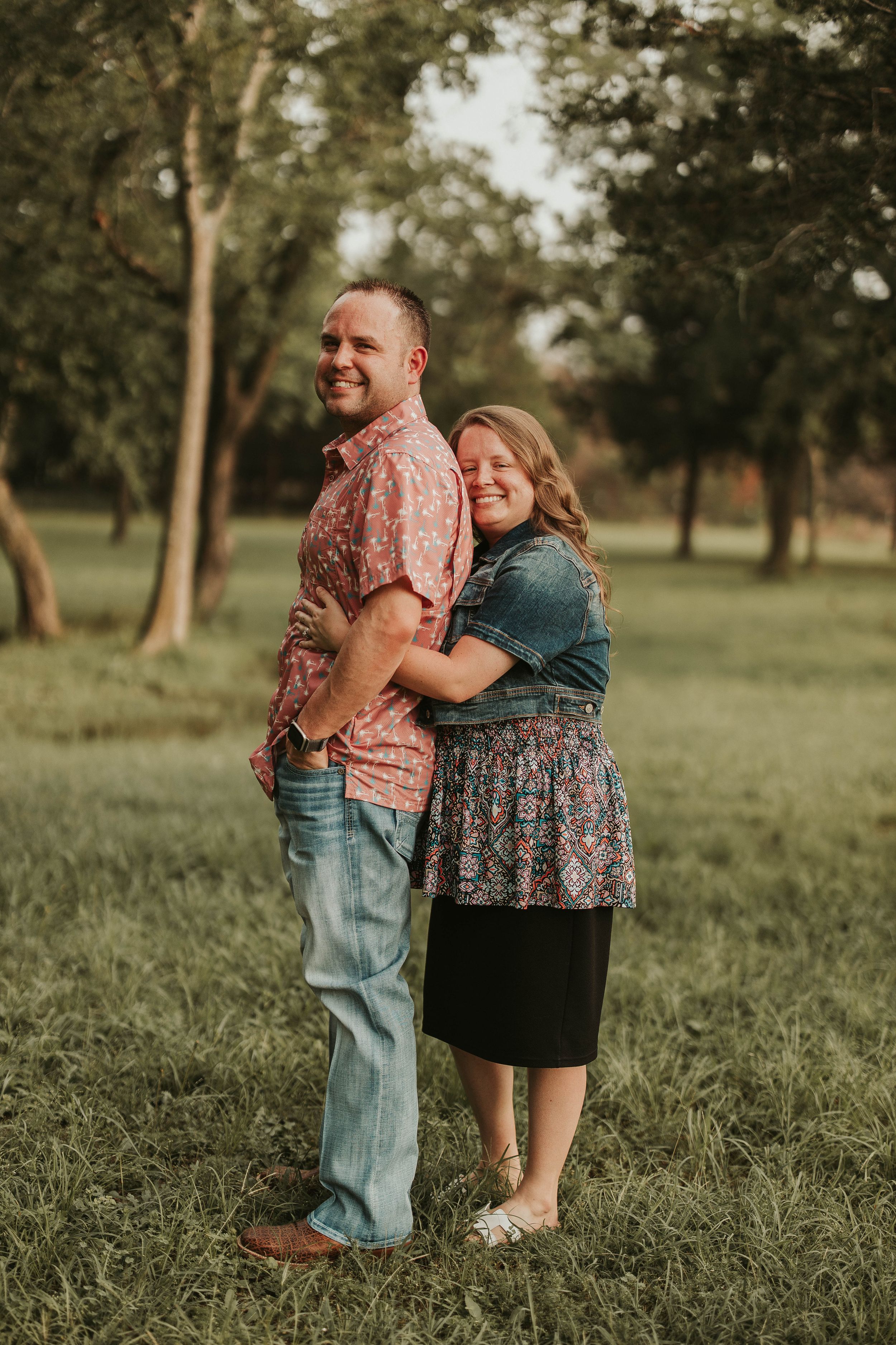 Family members hugging and showing affection during outdoor photo session.