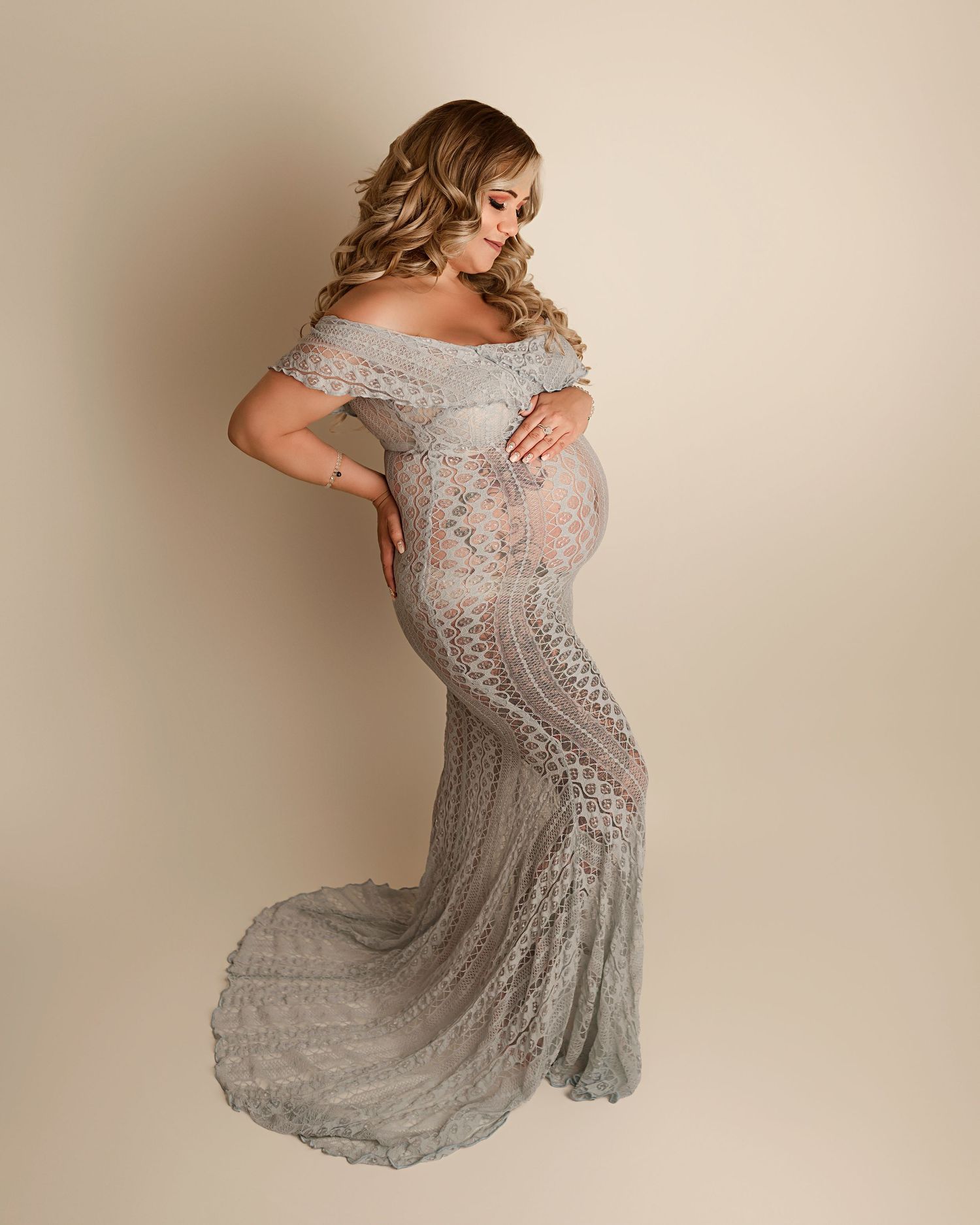 Best maternity photographers California, woman posing in silver maternity gown