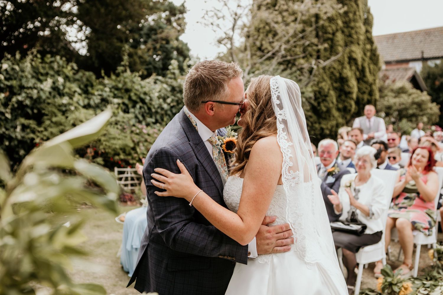 bride and groom having first kiss in ceremony