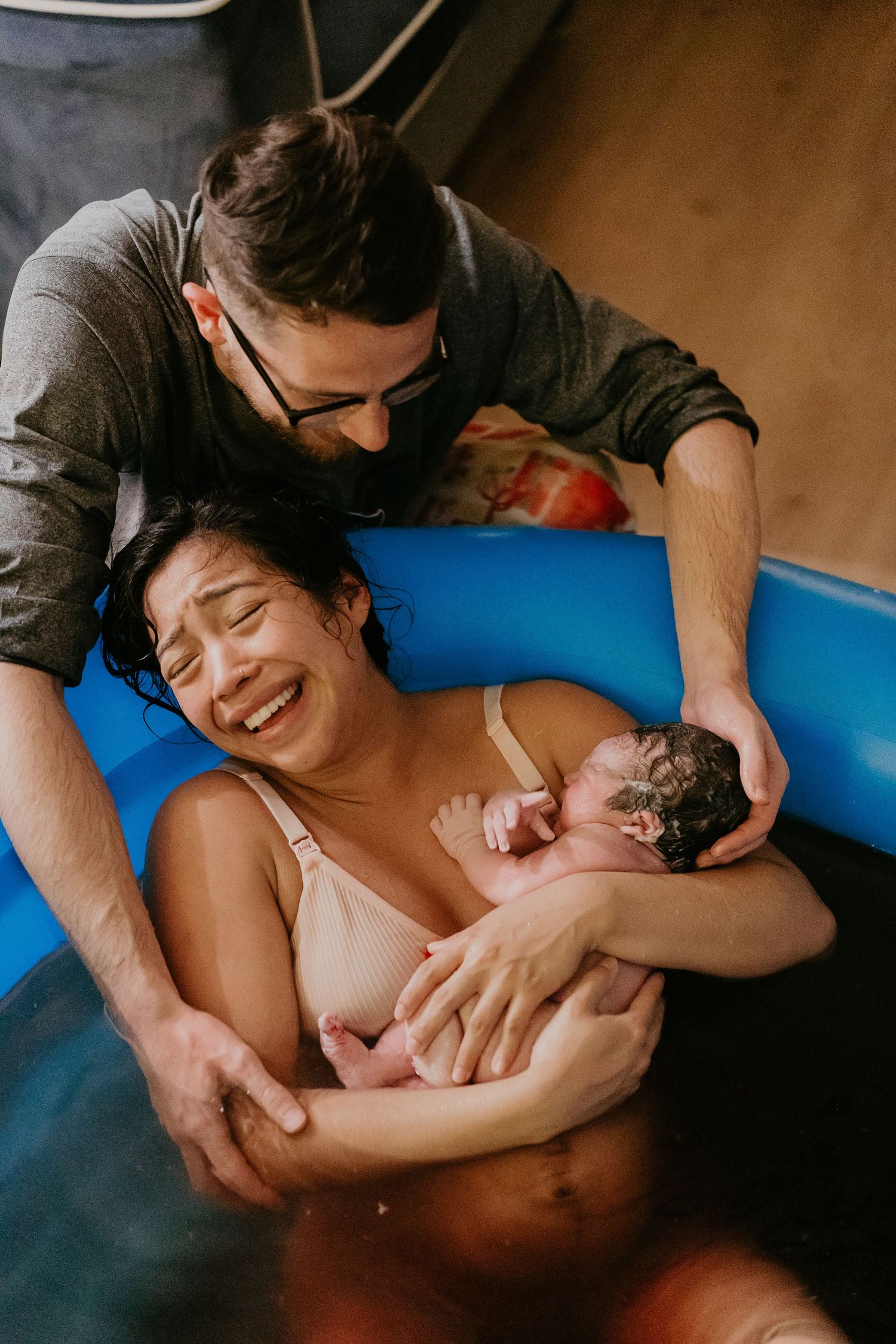 mom and dad welcome first baby. at home water birth dallas texas birth photographer.