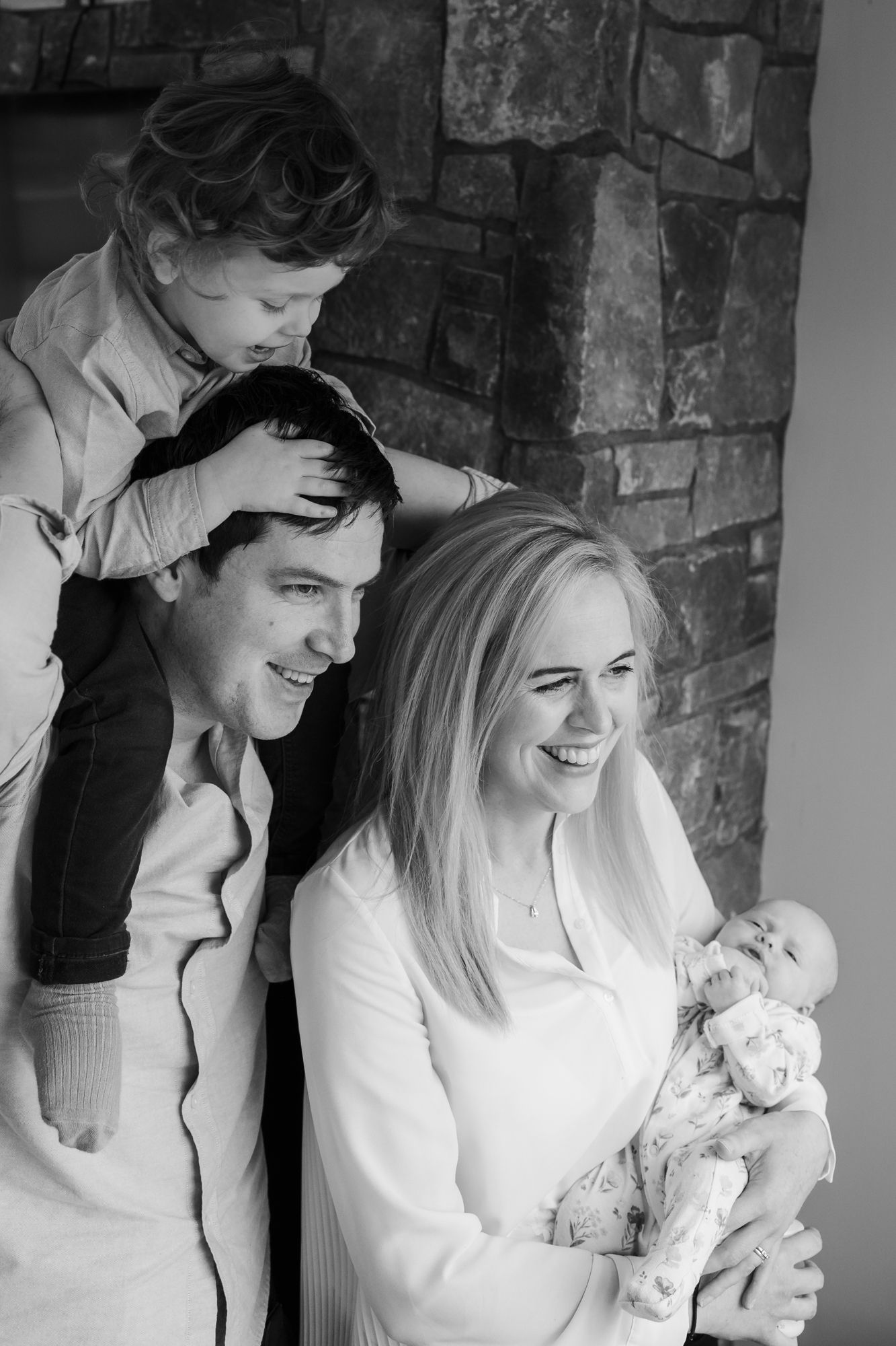 Black and white portrait of a loving family sharing tender moments together with their infant child.