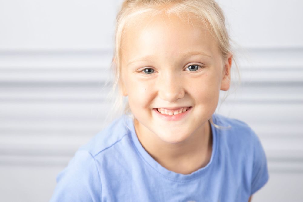 girl in light blue shirt smiling