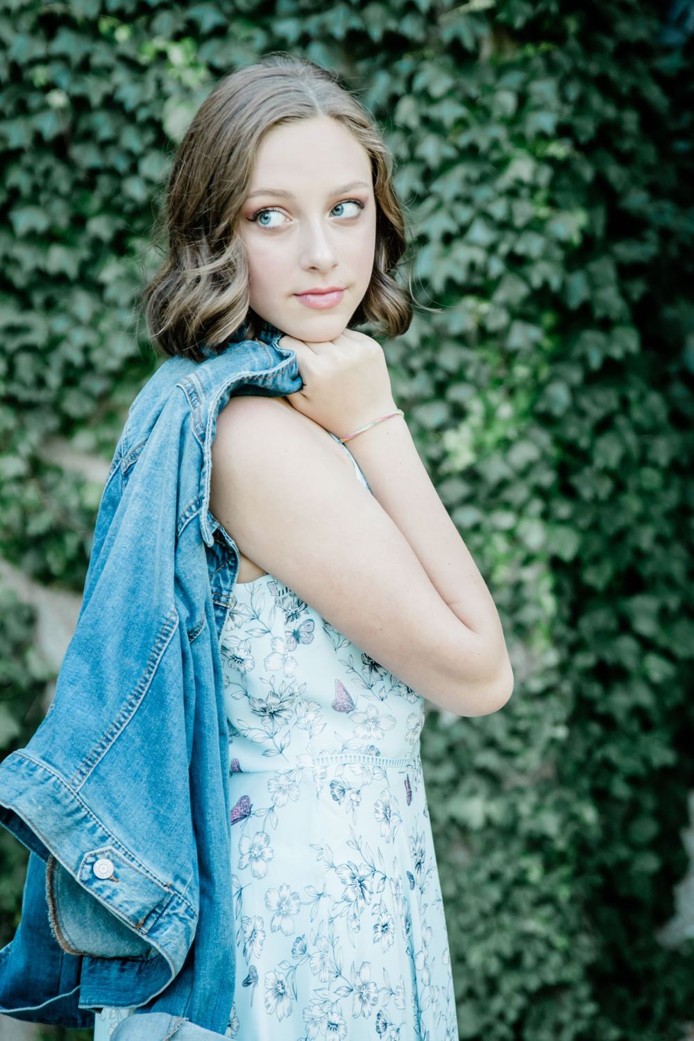 girl looking over shoulder with jean jacket
