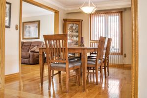 Open concept living area with hardwood floors and wooden trim throughout.